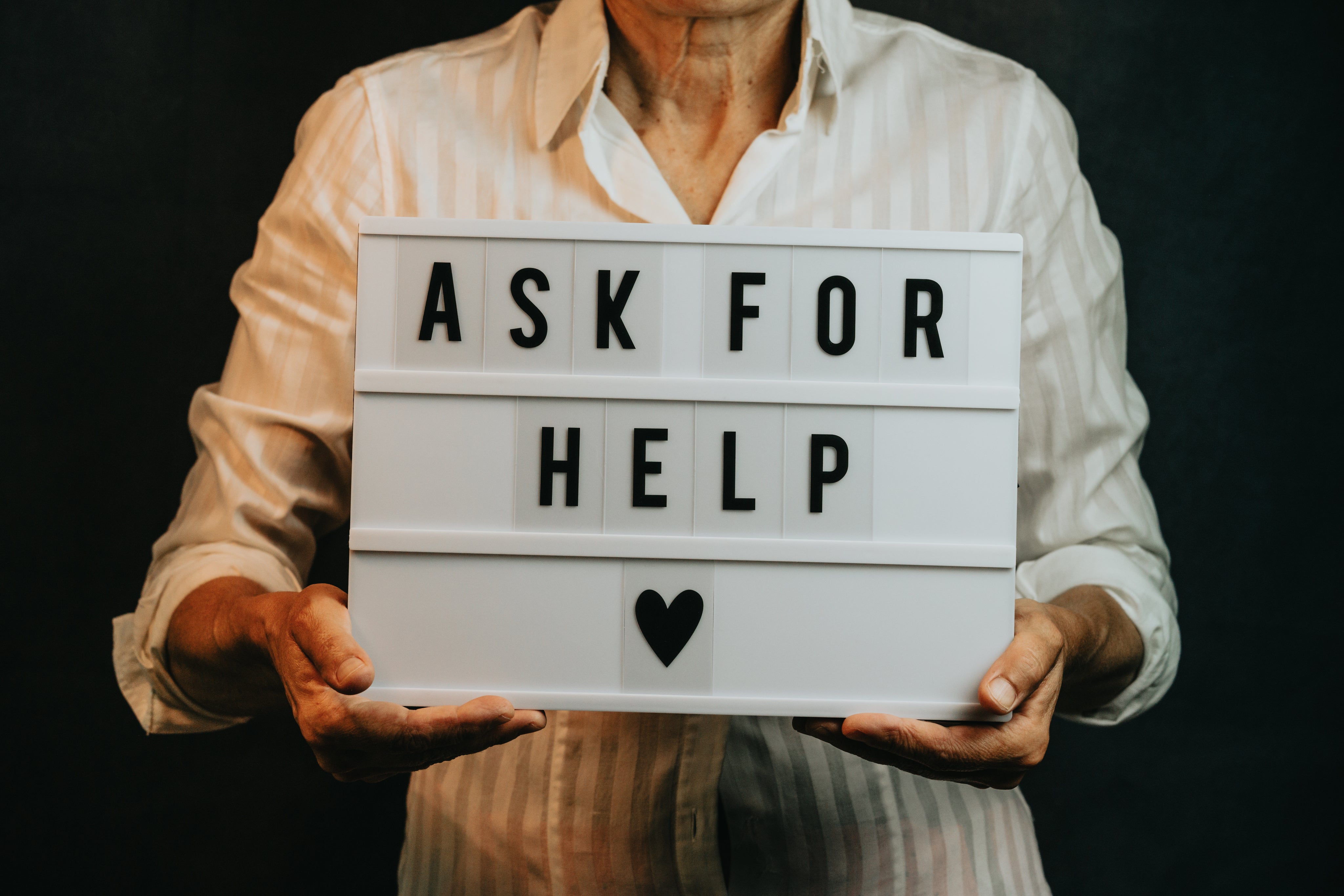 person-holds-a-sign-that-says-ask-for-help.jpg